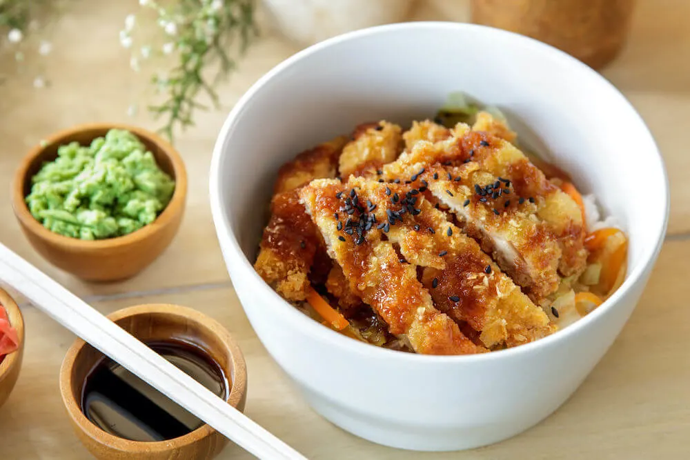 portrait of japanese food chicken katsu don served with soy sauce and wasabi