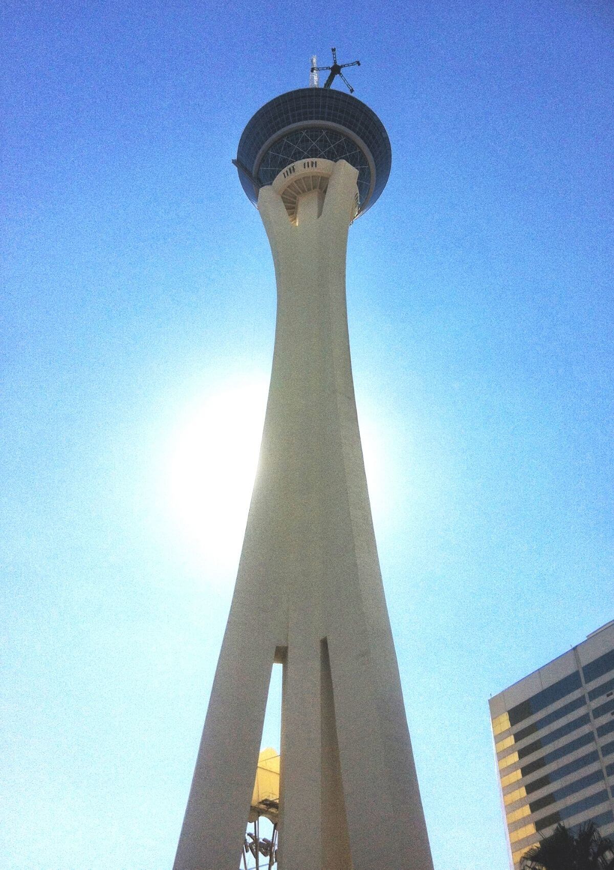 View at the top of the Stratosphere Hotel in Las Vegas, Nevada. The very  top of the tower, the 'Big Shot' ride, is pictured against a blue cloudy  sky. Copy space on