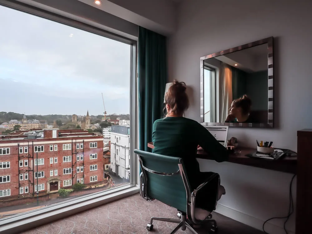 A person standing in front of a window Description automatically generated