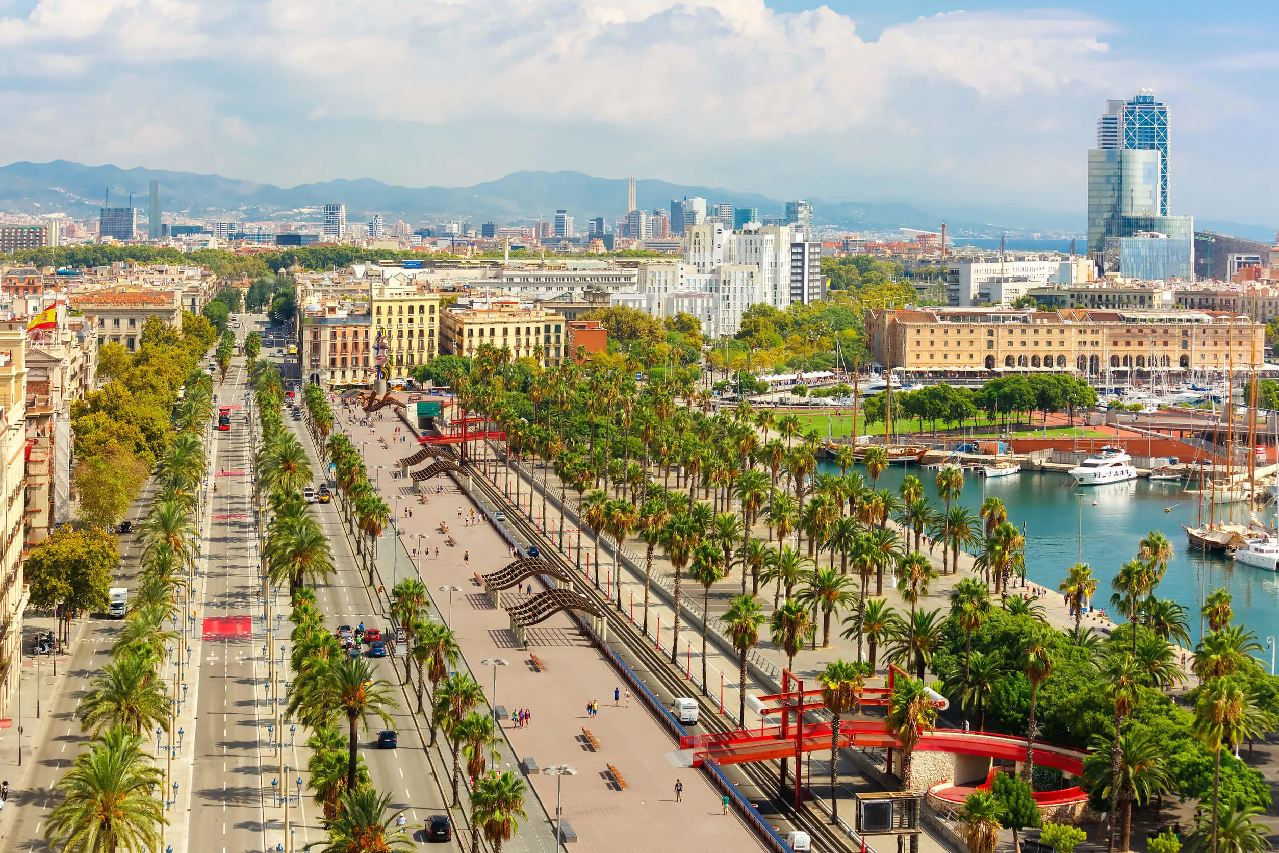 Aerial view over Passeig de Colom or Columbus avenue, La Barceloneta and Port Vell marina from Christopher Columbus monument in Barcelona, Catalonia, Spain