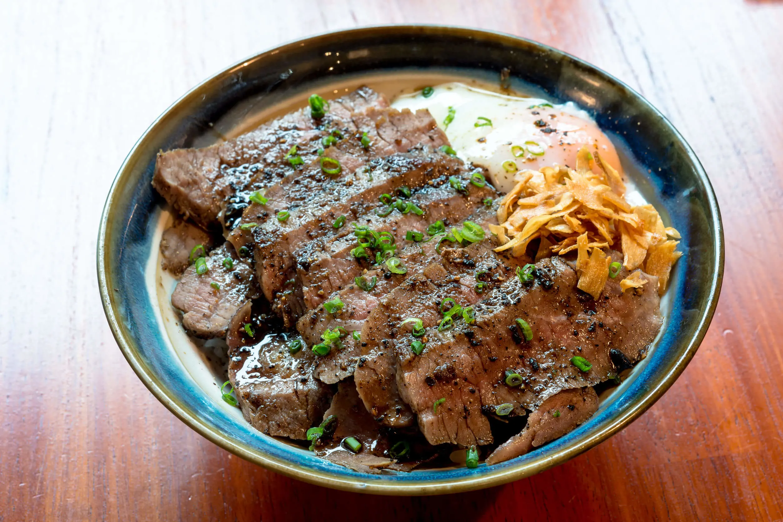 Beef Steak Donburi with egg and fried garlic