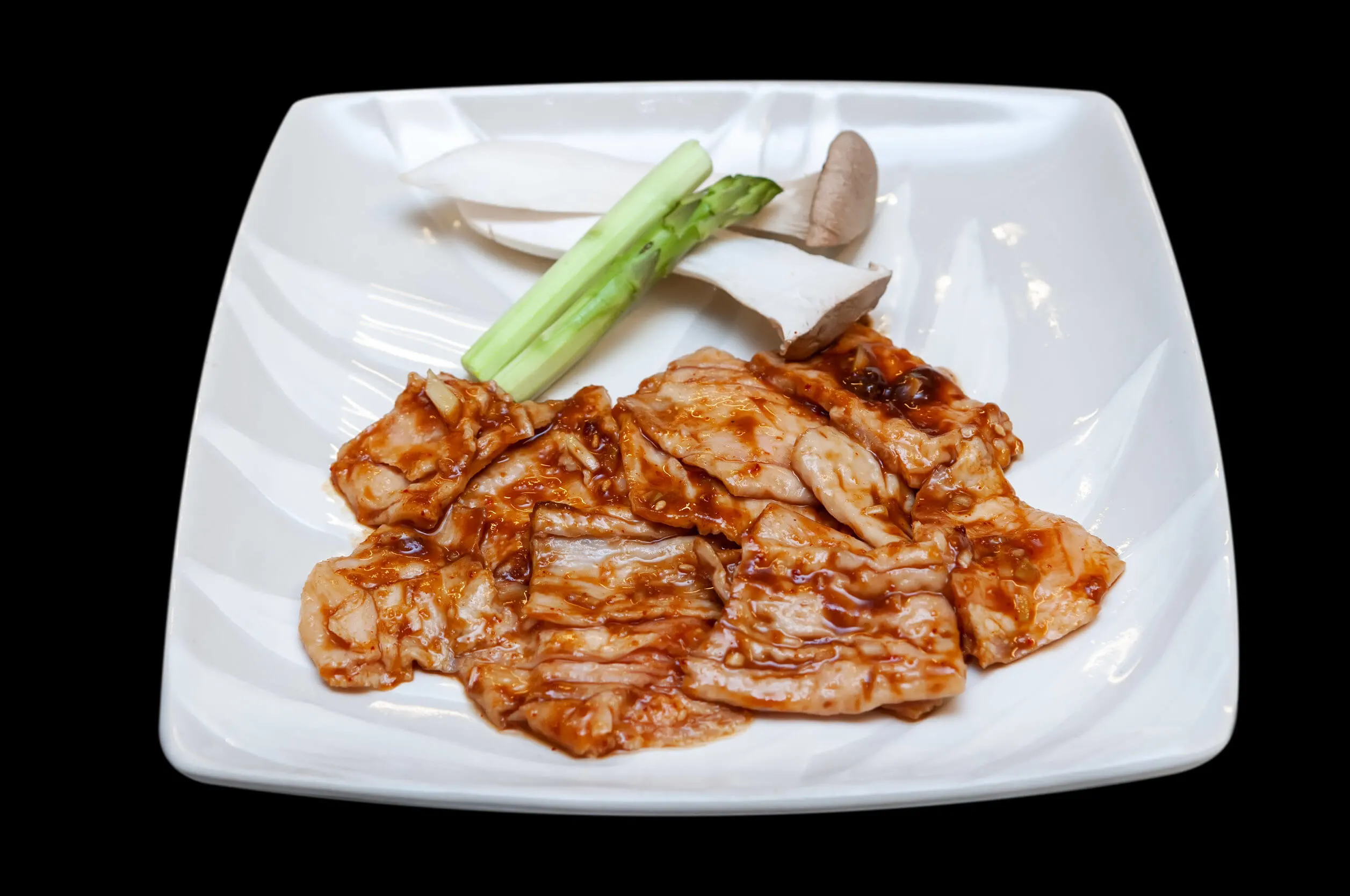 Japanese beef intestine yakiniku menu in white plate dicut from black background.