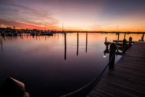 The marina at Key Largo as the sunsets Sunset over Key Largo and the marina with its fishing boats in the background and one of the many piers in the foreground.