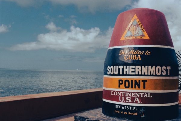 Southernmost point in the Continental US marked by a bolder in Key West, Florida. Cleared marked is the distance of 90 miles from Key West to Cuba.