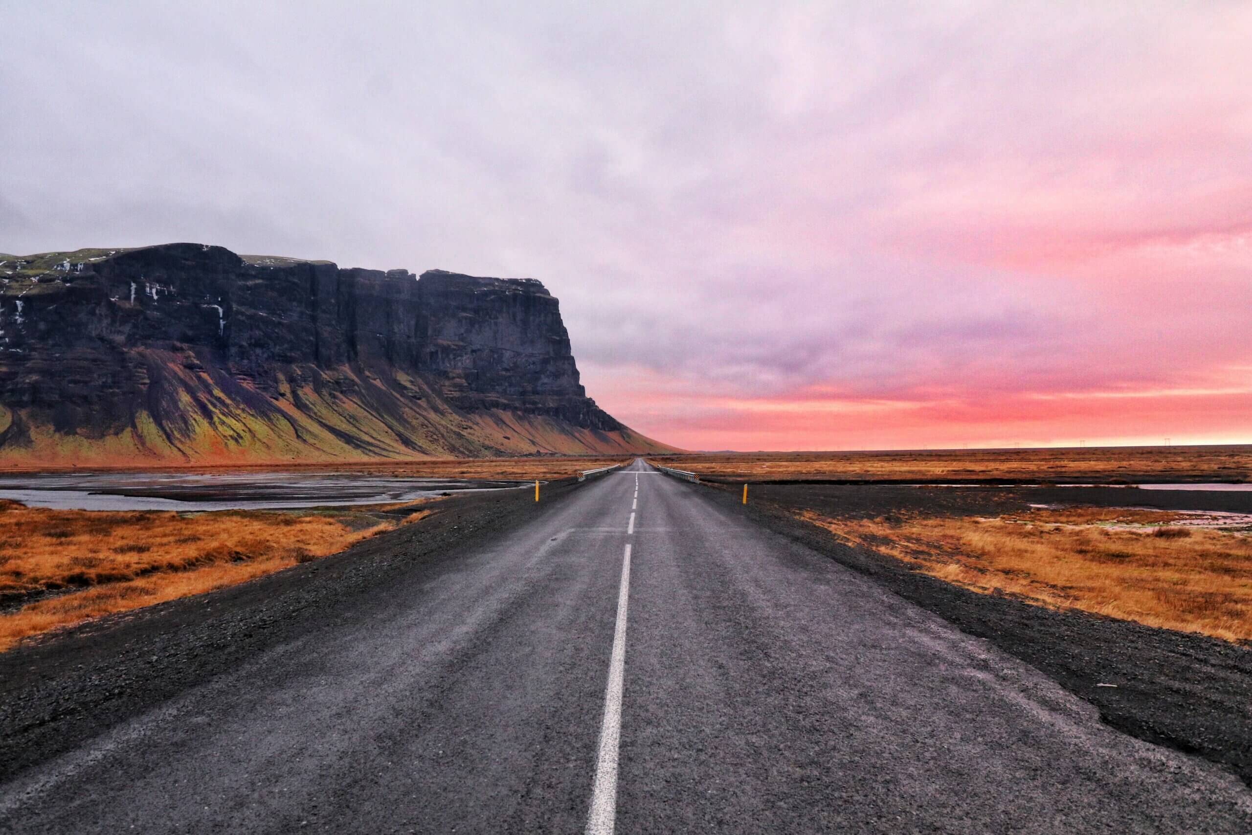 asphalt road and a cliff in Iceland