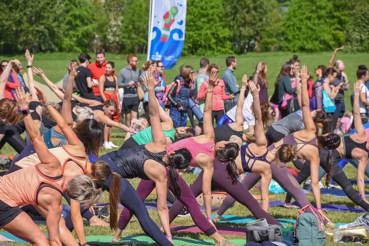 festival-goers doing at outdoor yoga class at wellfest yoga festival london 2023