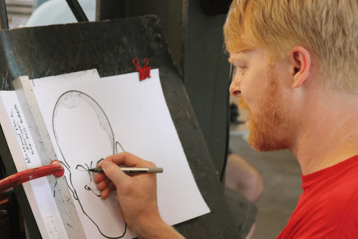 caricature artists drawing a portrait of someone on la rambla