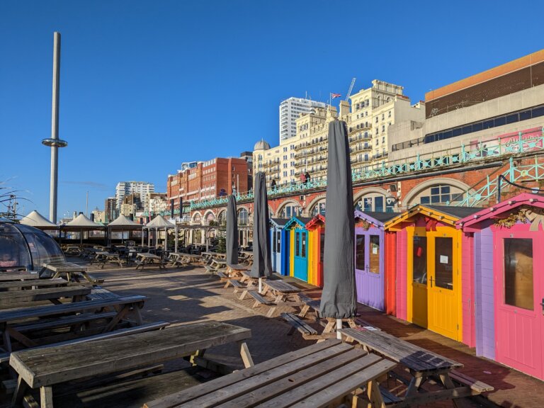 Colourful beach huts by Brighton pier.