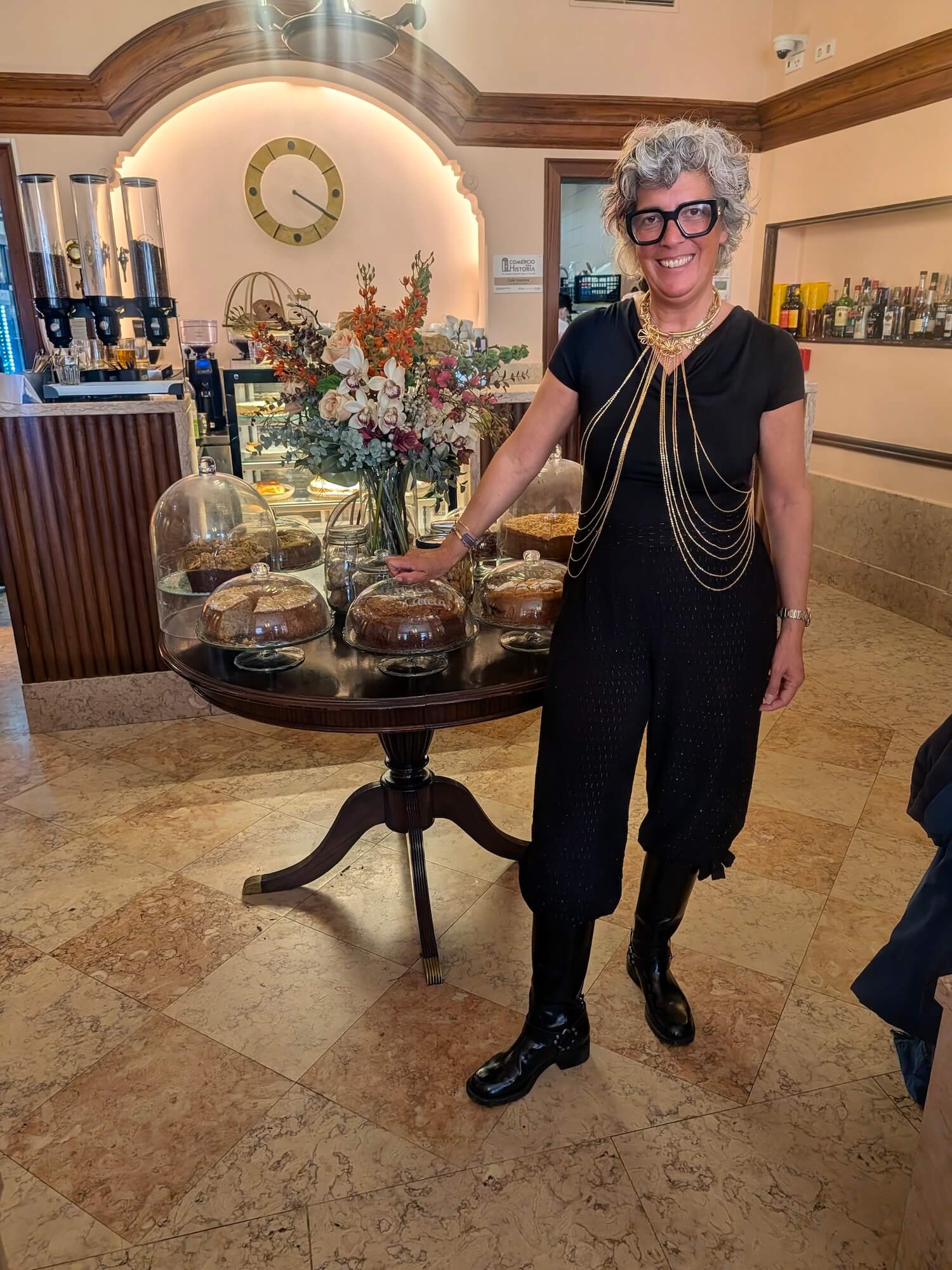 The owner of Cafe Calchina standing by the cakes