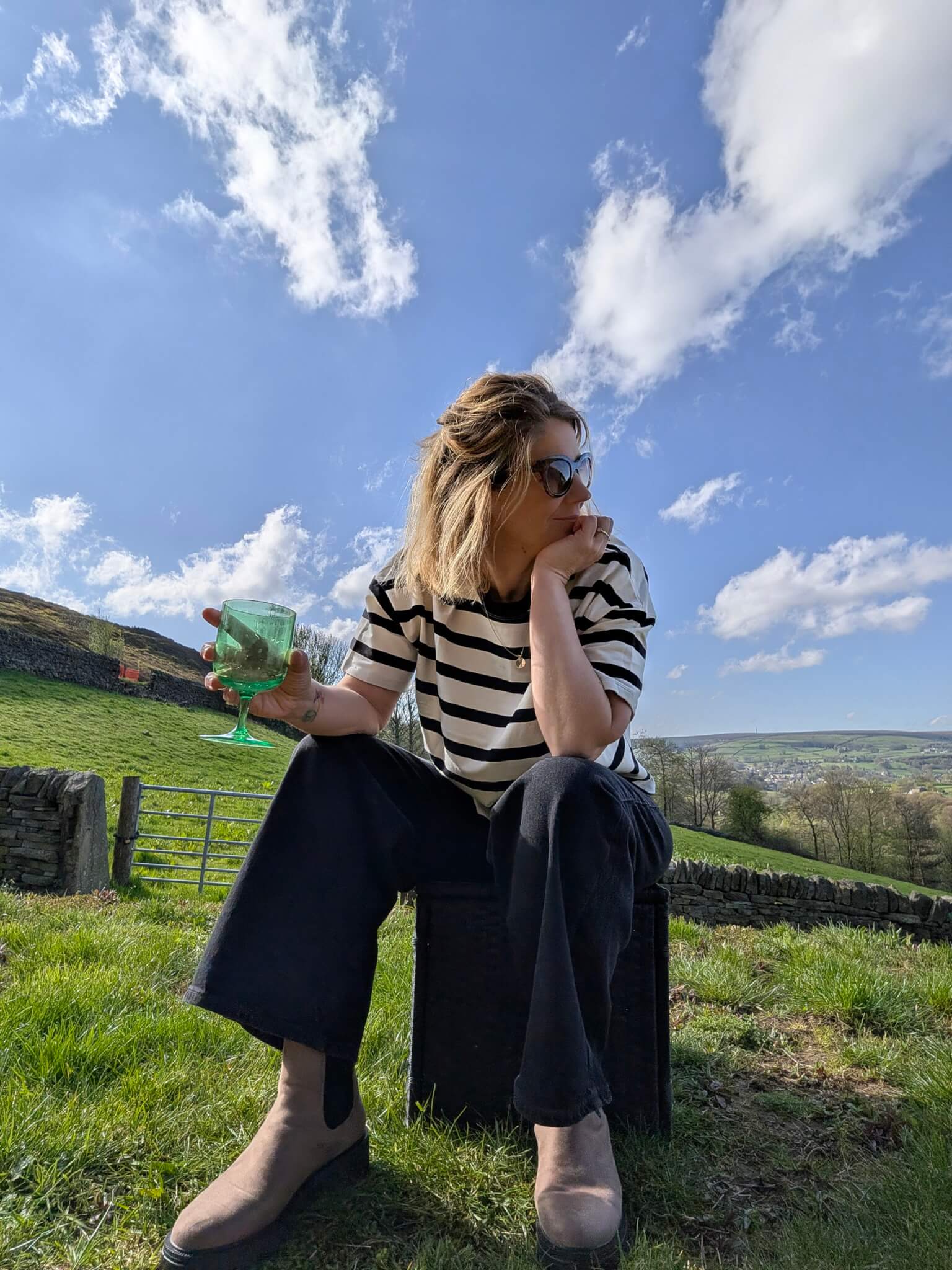 sitting down stripey top and jeans 