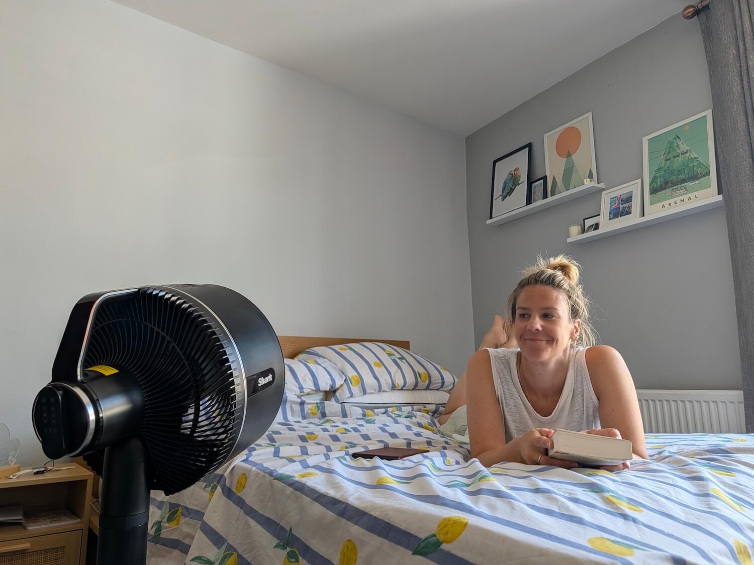 me lying on the bed with the fan at me
